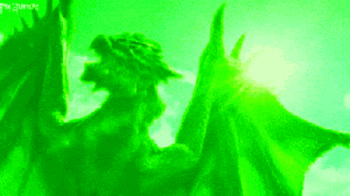 a green dragon is flying in the air with the sun behind it