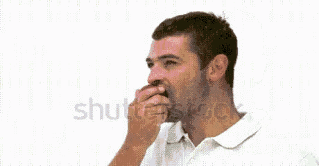 a man is eating a red apple on a white background .