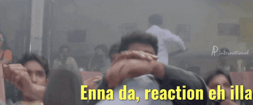 a group of men are sitting in front of a sign that says " enna da "