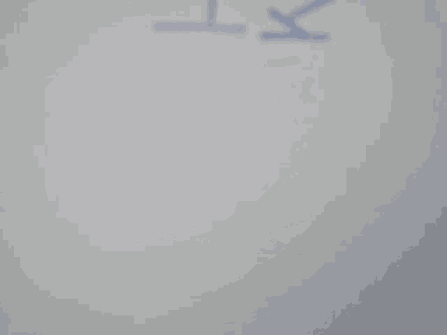 a close up of a white wall with a gray gradient in the middle .