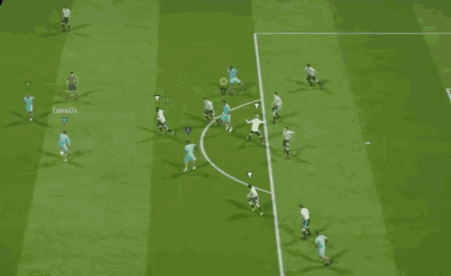 a soccer game is being played on a field with a yellow circle in the middle of the field