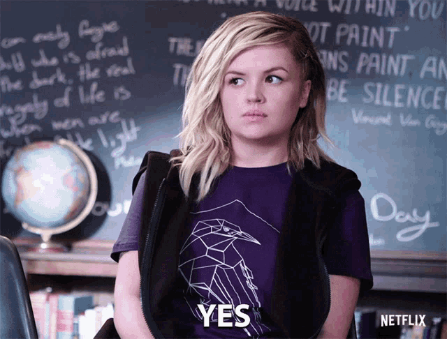 a woman wearing a purple shirt says yes