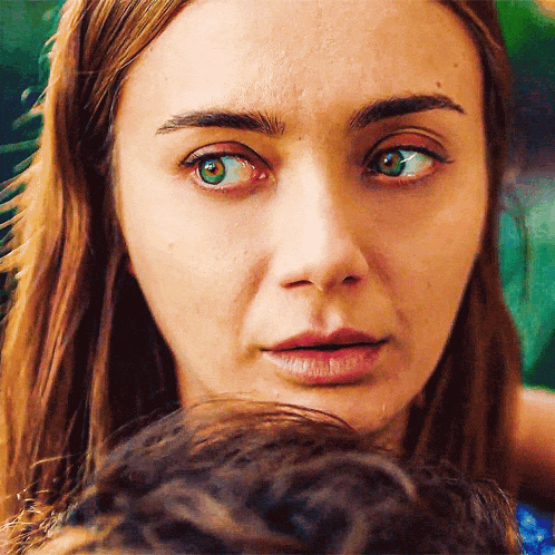 a close up of a woman 's face with her eyes closed