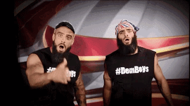 two men standing next to each other wearing black shirts that say #demboys