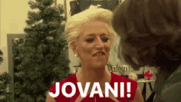 a woman in a red dress says jovani while standing next to another woman .