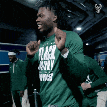 a man is wearing a green shirt that says black history