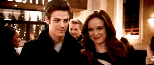 a man and a woman are standing next to each other in front of a restaurant .