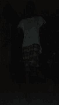 a person wearing a plaid shirt and a white tank top