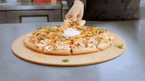 a pizza with a lot of toppings on it being sliced
