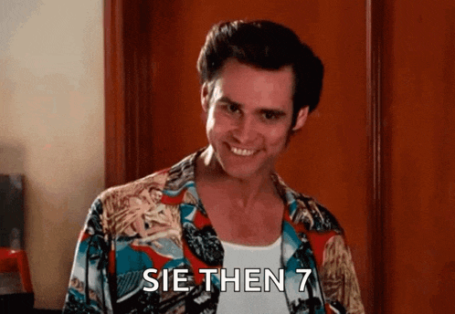 a man in a hawaiian shirt is smiling and says sie then 7