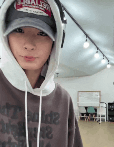 a person wearing a hoodie and a hat that says baller on it