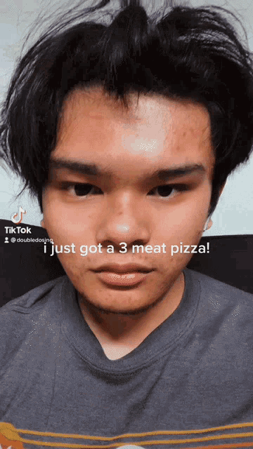 a young man 's face is shown with the caption " i just got a 3 meat pizza " on it
