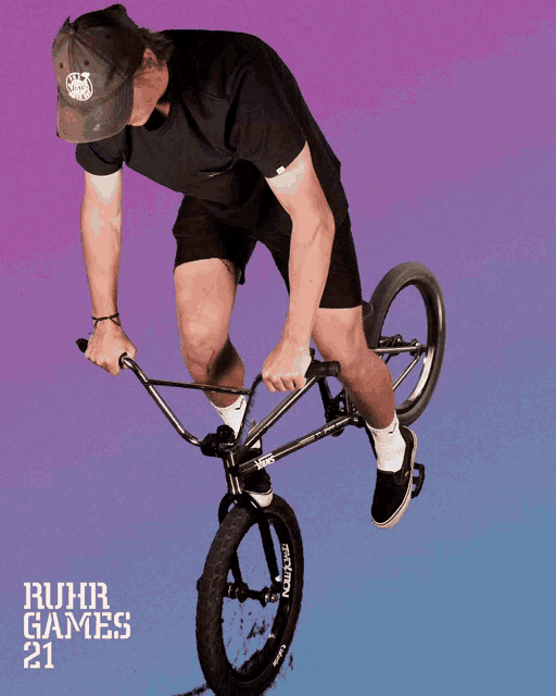 a man is riding a bike with ruhr games 21 written on the bottom