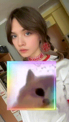 a woman taking a selfie with a rainbow frame around her
