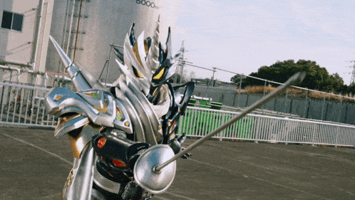 a knight with a sword is standing in front of a fence that says 5000m