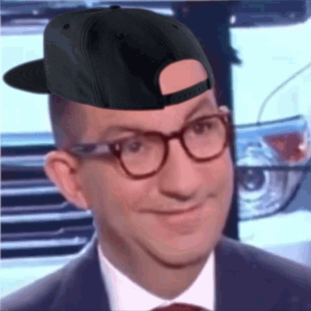 a man wearing glasses and a black hat with the word gucci on it