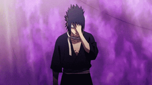 a man in a black kimono is covering his face with his hand .