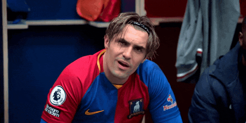 a soccer player in a locker room wearing a nike jersey
