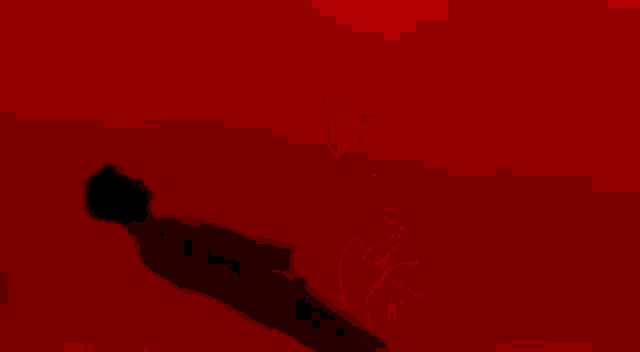 a man is standing in front of a red wall with a red background .
