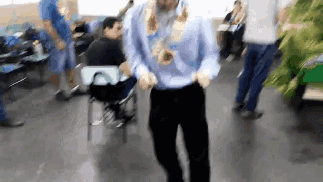 a blurry picture of a man in a blue shirt dancing
