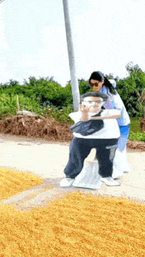 a woman is pushing a statue of a man