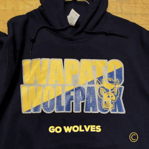a hoodie that says " wapato wolfpack " and " go wolves "
