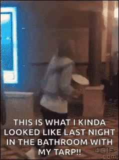 a person is dancing in a bathroom with a tarp .