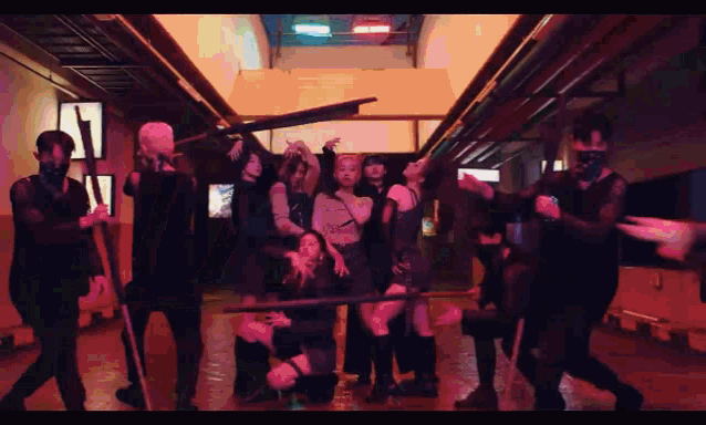 a group of people are posing for a picture in a dark room