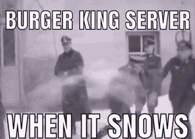 a black and white photo of a group of men standing in the snow .