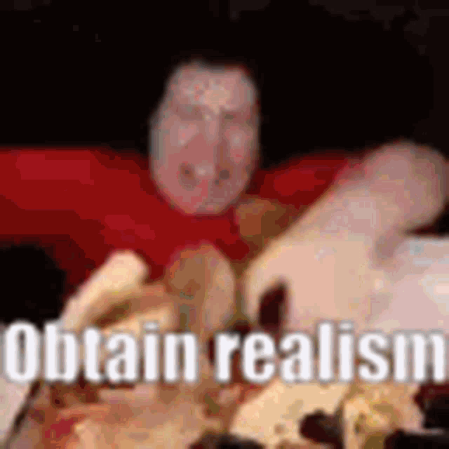 a man in a red shirt is sitting at a table eating a pizza .
