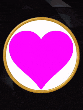 a white circle with a pink heart in the center