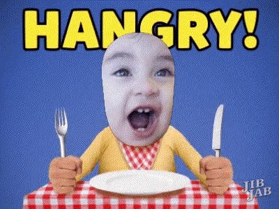 a baby is sitting at a table holding a fork and knife with the words hangry behind him