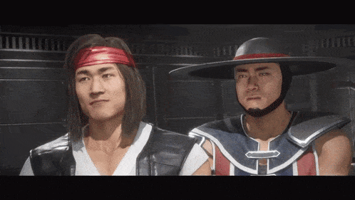 two men are standing next to each other and one has a bandana on his head