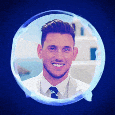 a man in a suit and tie is smiling in a blue bubble