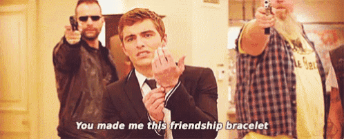 a man in a suit says " you made me this friendship bracelet " in front of two men holding guns