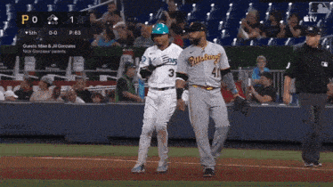 two pittsburgh baseball players walk on the field during a game