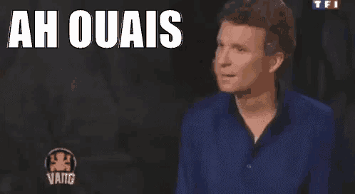 a man in a blue shirt is making a funny face in front of a sign that says `` ah ouais '' .