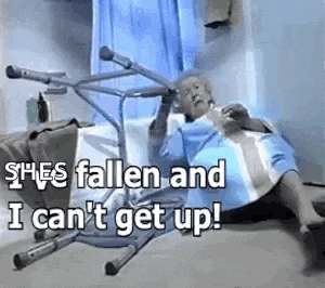 an elderly woman is laying in a hospital bed with a walker on the floor .
