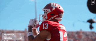 a football player in a red jersey with the number 13 on it