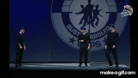 a group of police officers are dancing on a stage in front of a sign that says bust trolfo
