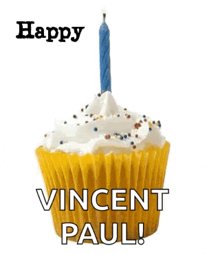 a blue cupcake with whipped cream and a candle on top .
