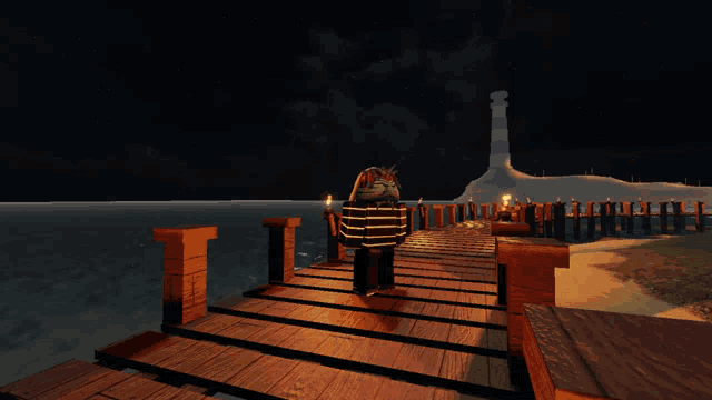a person standing on a wooden dock at night with a lighthouse in the background