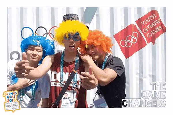 a group of young men are posing for a picture with a sign that says youth olympic games