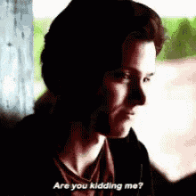 a man is looking out a window and says `` are you kidding me '' .