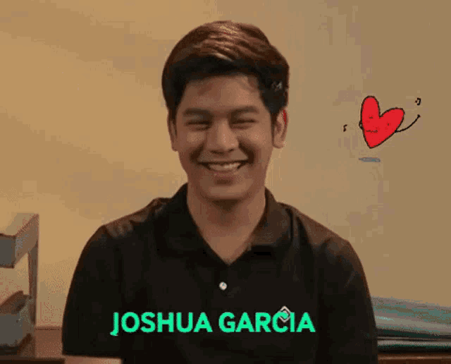 a young man in a black shirt with the name joshua garcia on it