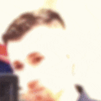 a blurry picture of a man 's face with sunglasses on .