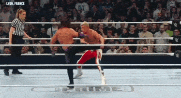 a wrestler is kicking another wrestler in a ring that says prime on the bottom