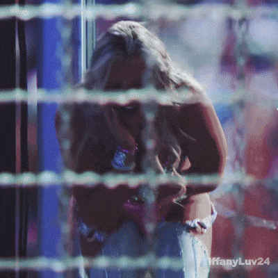 a woman behind a barbed wire fence with the hashtag tiffanyluv24 on the bottom