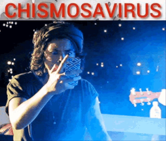 a man giving a peace sign in front of the word chismosaurus