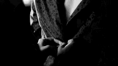 a black and white photo of a man and a woman standing next to each other .
